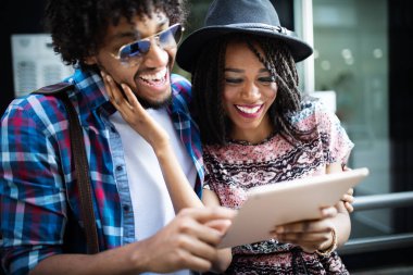 Kentsel şehir açık havada tablet kullanarak genç modern şık çift