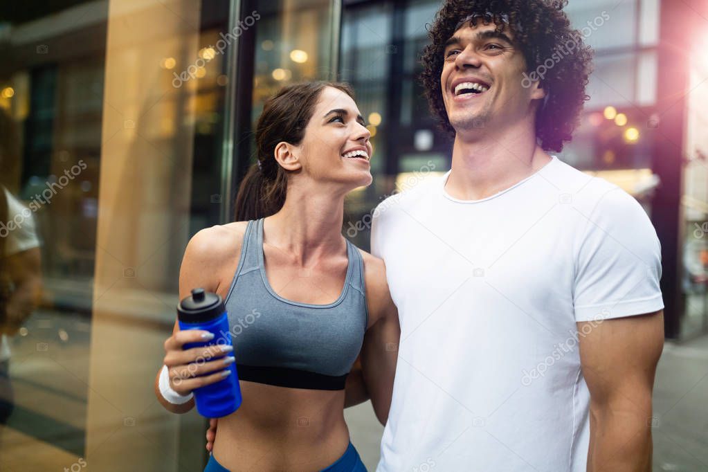 Portrait of young attractive happy fitness couple outdoor