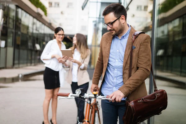 Happy business people discussing and smiling while walking together outdoor