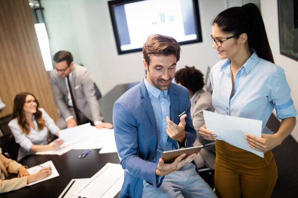 Business colleagues in conference meeting room during presentation