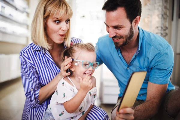 Feliz Familia Joven Eligiendo Gafas Tienda Óptica —  Fotos de Stock