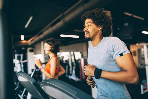 Teamwork in gym. Couple working exercise together. Healthy life concept