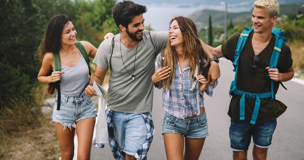 Group of happy people, friends with backpack at summer vacation outdoor