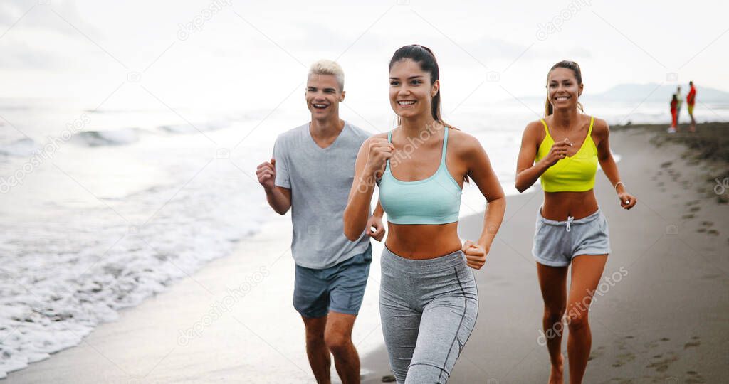 Fitness, sport, friendship and healthy lifestyle concept . Group of happy people running