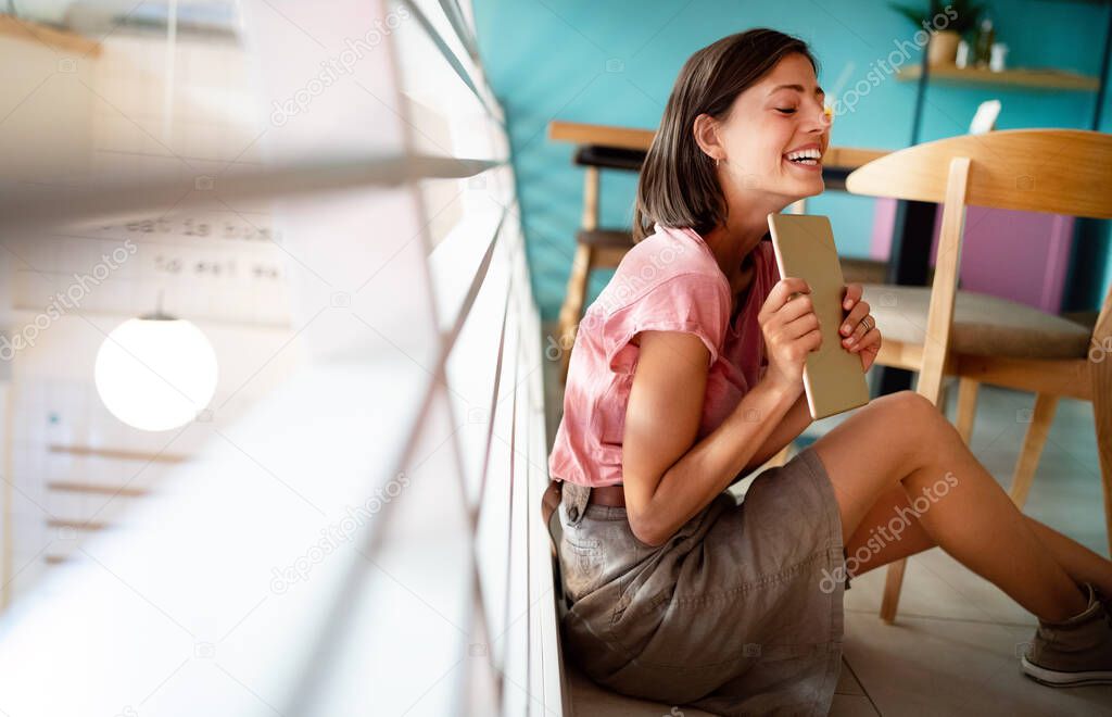 Portrait of beautiful student or businesswoman in smart casual using digital tablet