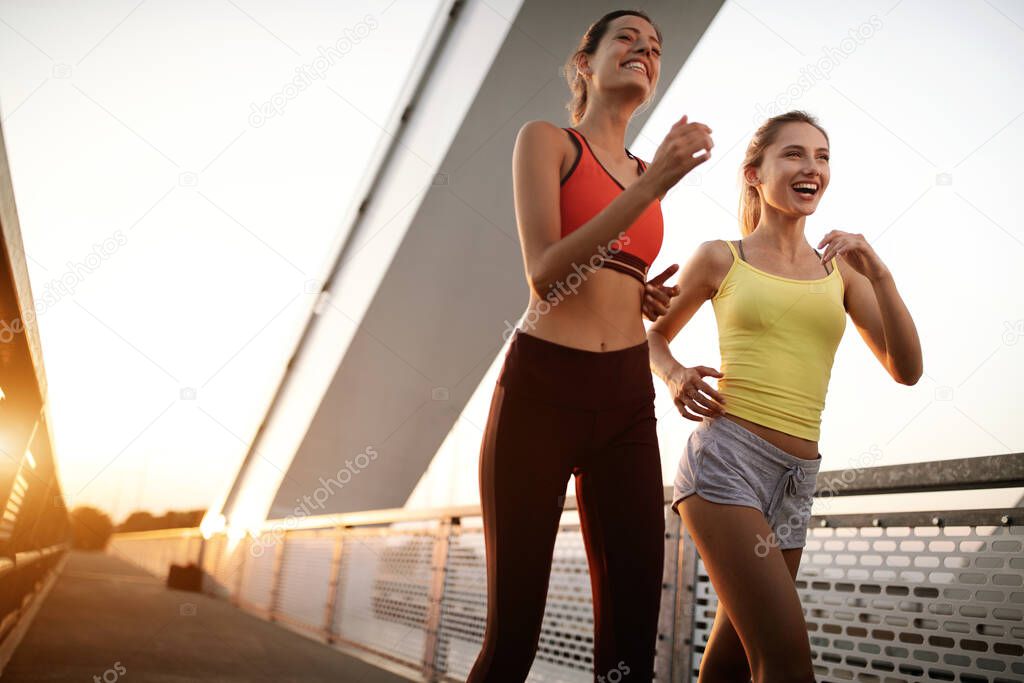 Beautiful fit women working out in a city. Running, jogging, exercise, people, sport concept