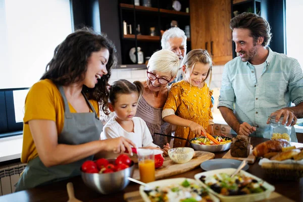 Portrait of happy family cooking in kitchen at home