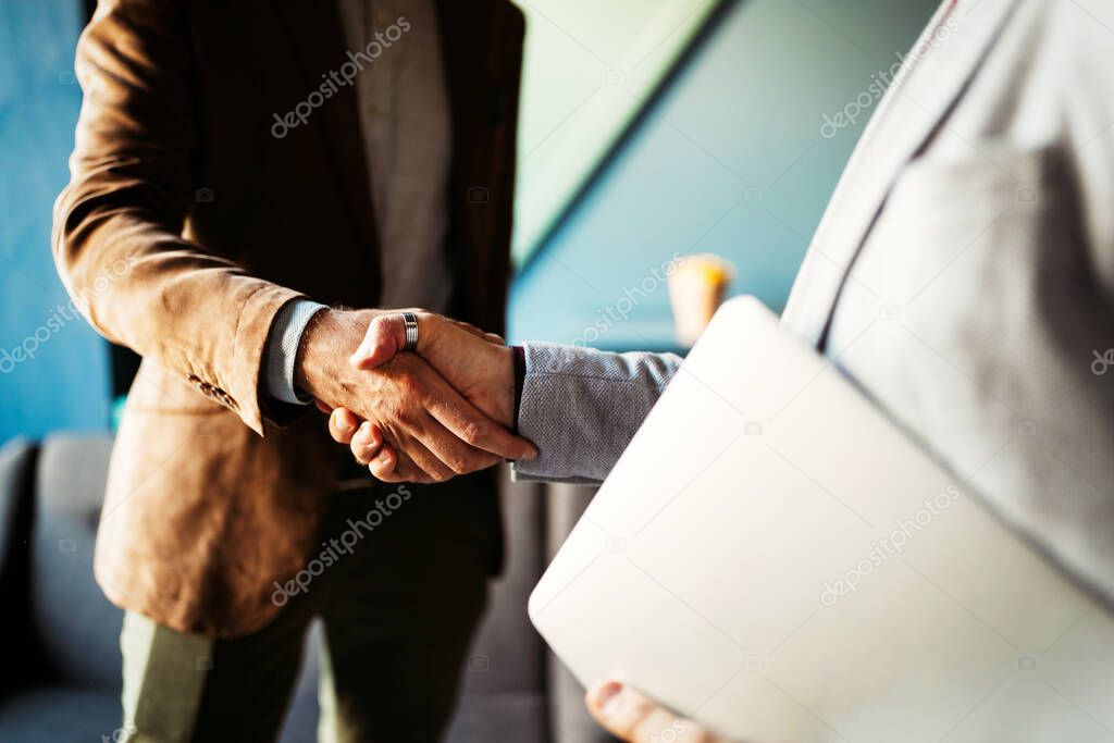 Closeup picture of happy businesspeople shaking hands, making an agreement.