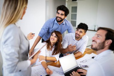 Girişimciler ve iş adamları birlikte çalışıyor, ofiste beyin fırtınası yapıyorlar.