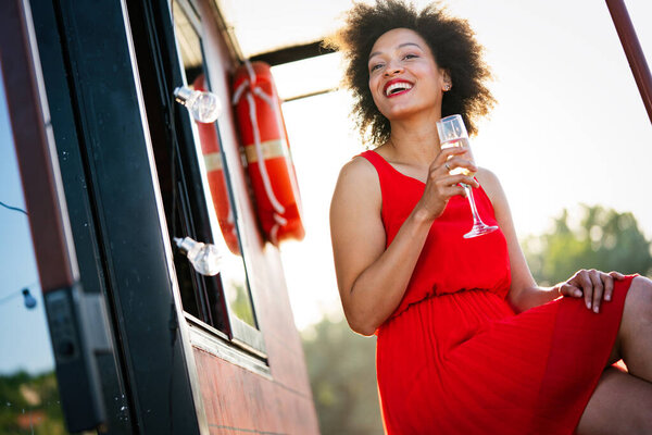 Summer lifestyle fashion portrait of young stylish black woman with drink