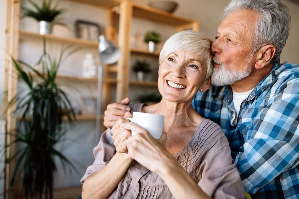 Senior Couple Relaxing Hugging Home Together — Stock Photo, Image