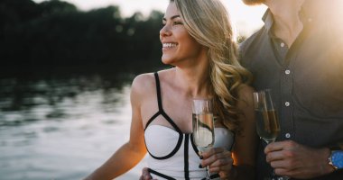 Mutlu genç çiftin bir randevusu ve teknede şampanya içmesi.