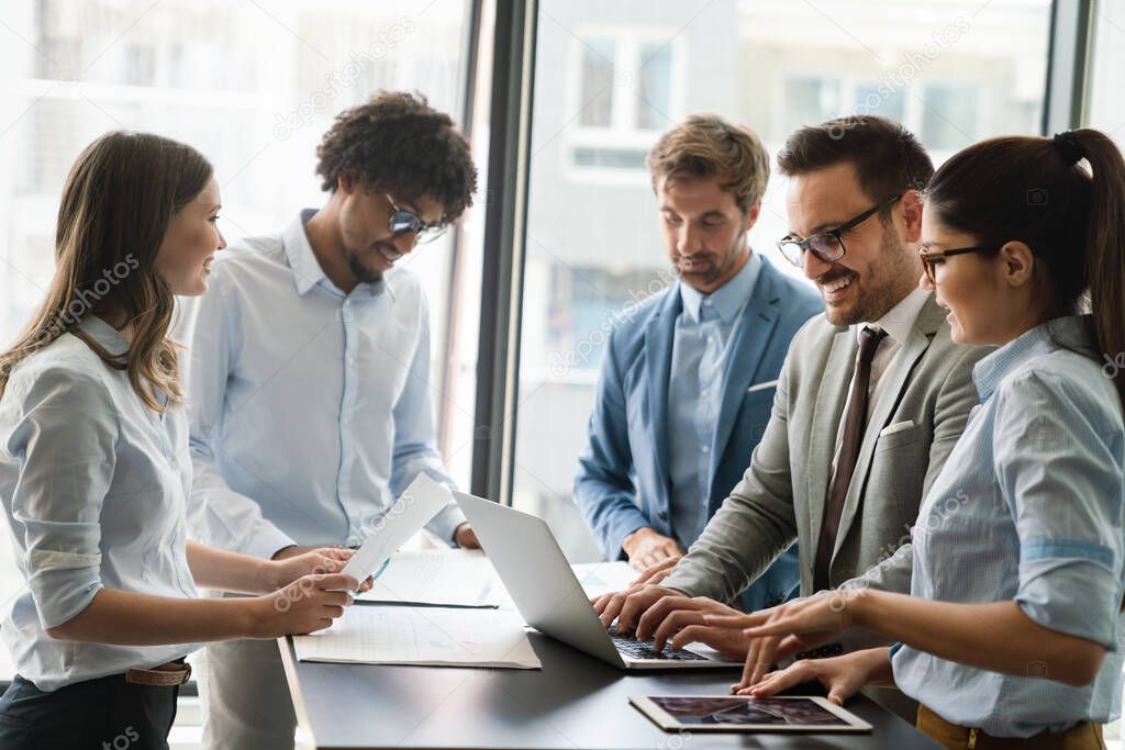 Portrait of successful business team working together in office