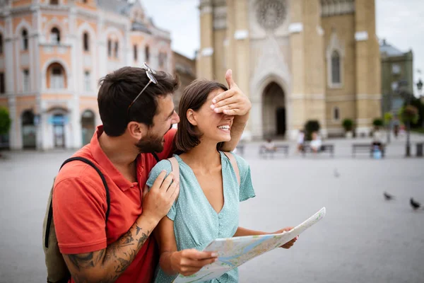 约会和旅游的概念 在城市里带着地图笑着快乐的夫妻 — 图库照片