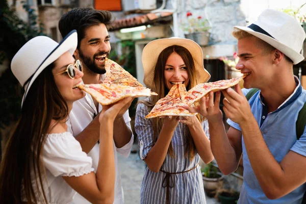 休暇中にピザを食べる友人の幸せなグループ — ストック写真