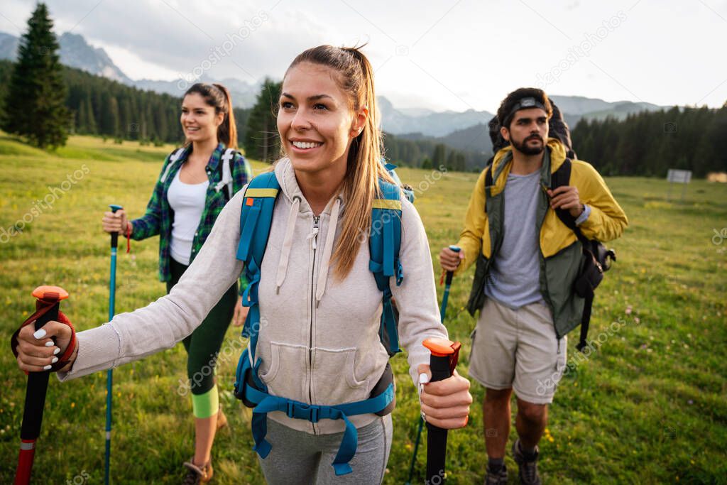 Friends hiking together outdoors exploring the wilderness and having fun