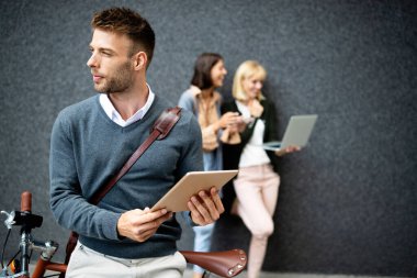 Dijital çağda yaşamak. Dışarıda elinde farklı dijital cihazlar tutan bir grup mutlu genç. teknoloji kavramı