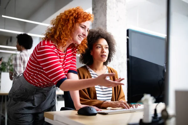 Programmers cooperating working at information technology company