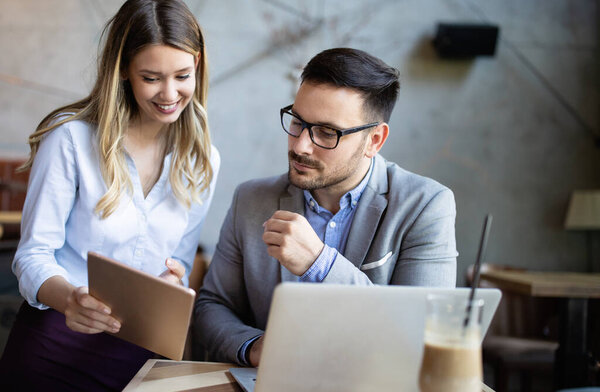 Happy business colleagues having conversation during coffee break