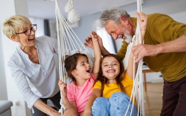 Birlikte oynayan mutlu yaşlı çift ve torunların portresi. Aile sevgisi kavramı