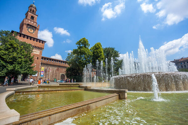 Milan, Italy - 25.06.2018: Sforza Castle - Castello Sforzesco and fountain in front of it.