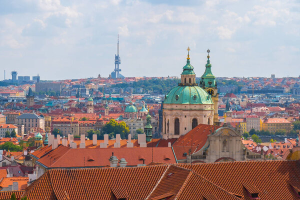 View over historic center of Prague, St. Nicholas Church, red roofs of Prague, Czech republic.