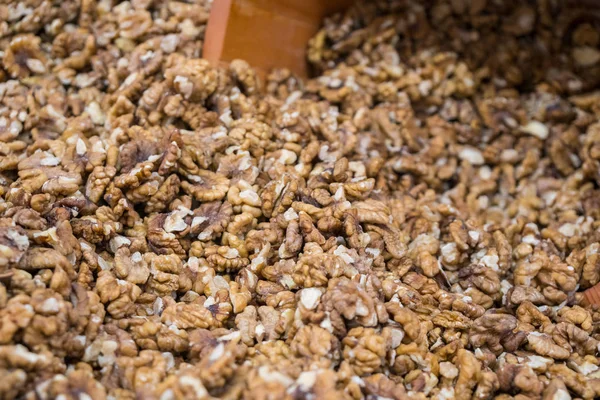 Full frame of peeled raw organic walnuts in the market. Walnut background texture.