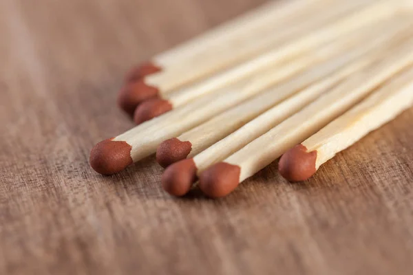 Wooden matches sticks on a wooden table background.