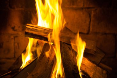 Wood burning in a cozy fireplace at home, keep warm. clipart