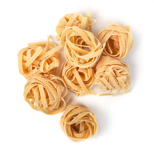 Uncooked nest of tagliatelle Italian pasta isolated on white bac — Stock Photo, Image