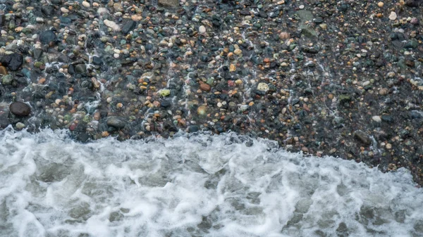 Ovanifrån av stenstrand med små vågor — Stockfoto