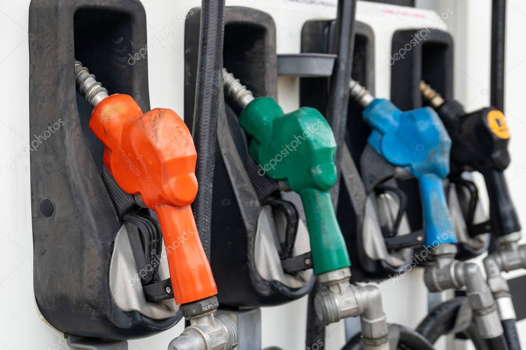 Colorful Petrol pump filling nozzles, Gas station in a service