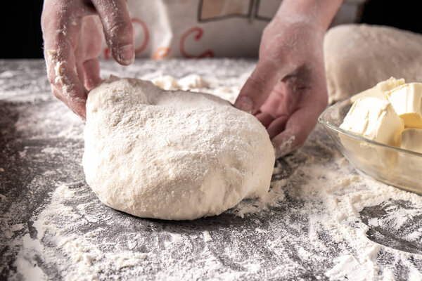 Making dough by female hands at bakery