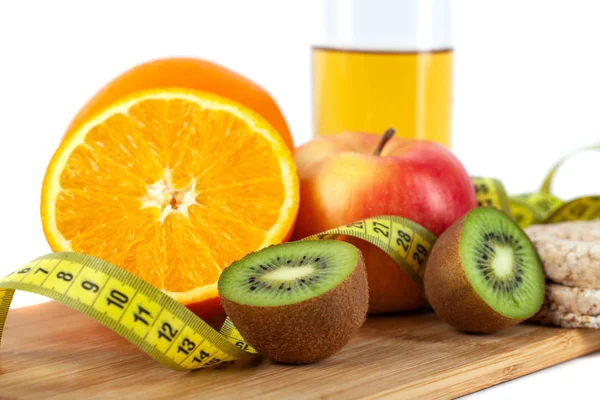 Apple, orange, kiwi with measure tape on white background — Stock Photo, Image