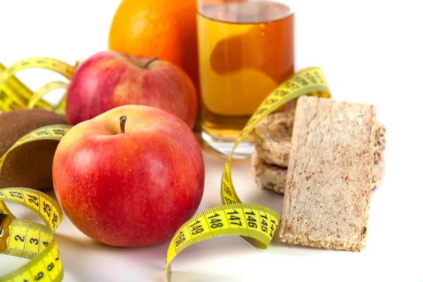 Apple, orange, kiwi with measure tape on white background — Stock Photo, Image