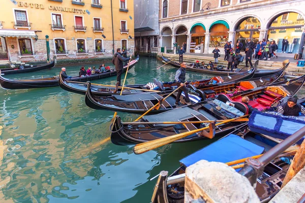 Venice, Italy - 13.03.2019: Venetian canal with gondolas and his — Stock Photo, Image