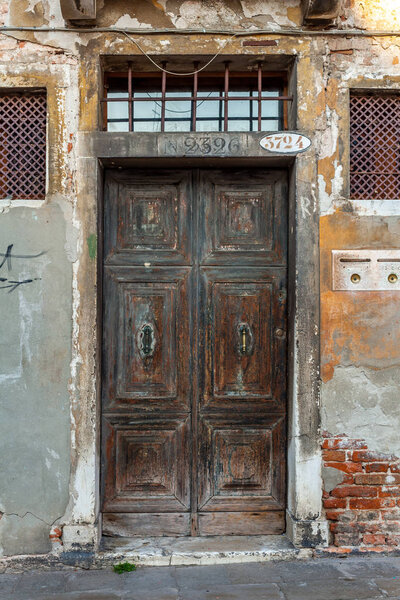 Venice, Italy - 14.03.2019: Vintage door in old buildings in Venice. Travel.