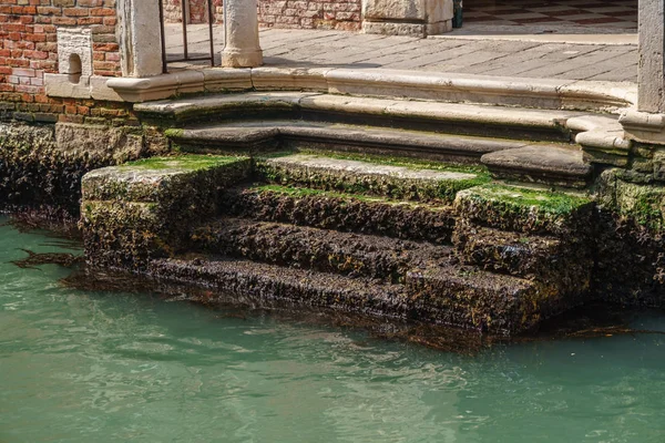Olhando para uma escadaria em um canal na cidade da lagoa Veneza. Tipo — Fotografia de Stock