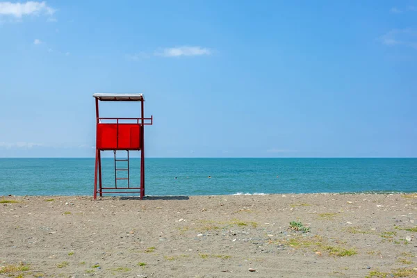 Red lifeguard rescue tower on the Anaklia beach. Landscape