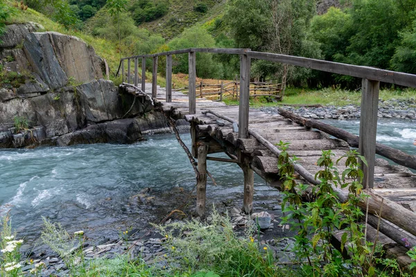 Old wooden bridge over a river Argun in Upper Khevsureti, Georgia. Travel