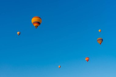 Mavi gökyüzüne karşı üç sıcak hava balonu. Aşağıdan güzel renkli sıcak hava balonları manzarası. Seyahat, Kapadokya