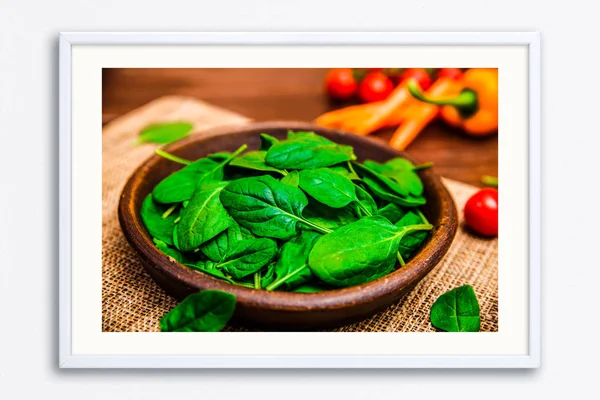 Spinach leaves in bowl. Raw fresh vegetable.