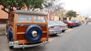 Lima, Peru. December 17, 2017. Rear and side view of an old blue Ford Super DeLuxe Woodie Station Wagon 1941 built by Ford Motor Company in the USA. This vehicle was exhibited in Pueblo Libre district of Lima clipart