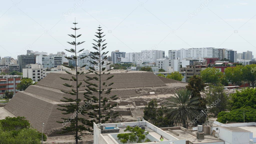 Scenic view of the circa two thousand years old pyramid called Huaca Huallamarca located in San Isidro district of Lima surrounded by modern buildings and houses