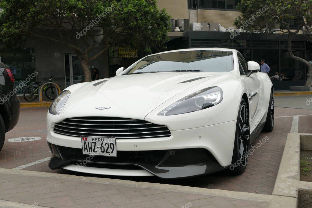 Lima, Peru. February 8, 2018. Front and side view of a mint condition white Aston Martin Vanquish coupe parked in San Isidro district of Lima. In the background there are a built construction and trees.