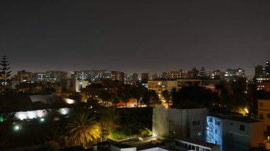 Modern panoramic San Isidro district of Lima by night and partial view of the pyramid called Huaca Huallamarca with circa 2000 years old.   clipart