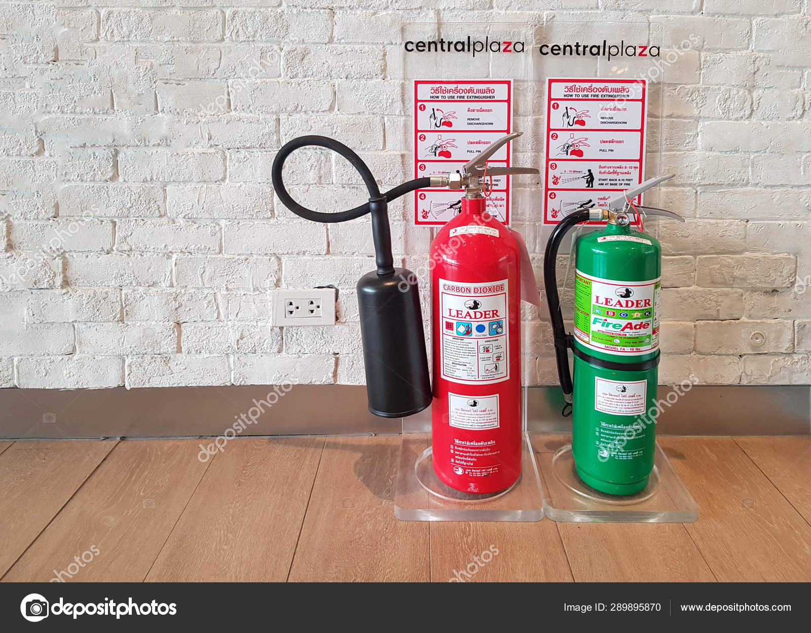 New Red And Green Fire Extinguishers On Floor In Building Stock