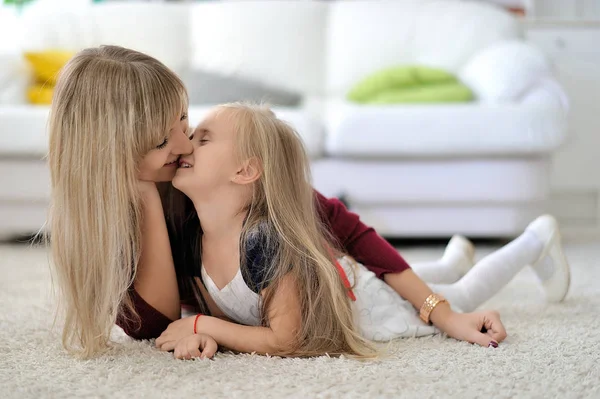 Beautiful Mom and Daughter at Home.