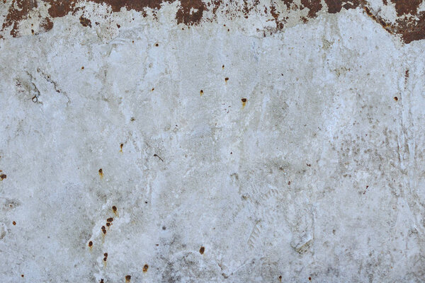 Abstract texture of an old rusty metal sheet with white paint. Close-up.