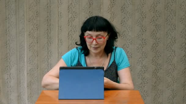 Pretty Adult Woman Red Glasses Emotionally Uses Tablet — Stock Video